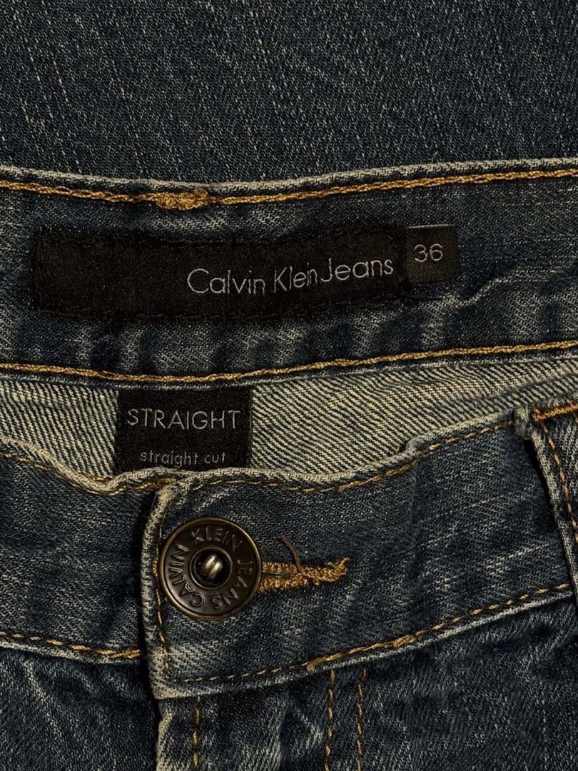 Calvin Klein Jeans Straight Cut Size 36 (Category: Jeans) located in Mandaluyong City. Submitted by zaiampiloquio (Listing ID 1465608488, Image 3). Description: - Brand: Calvin Klein - Color: Dark blue wash with natural thigh and knee fading - Fit: Straight cut - Size: Tag size 36 - Features: Classic five-pocket design, branded button closure, and back leather patch - Condition: Solid everyday denim with regular wear.