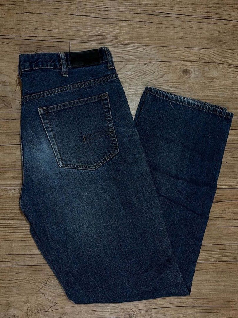 Calvin Klein Jeans Straight Cut Size 36 (Category: Jeans) located in Mandaluyong City. Submitted by zaiampiloquio (Listing ID 1465608488, Image 1). Description: - Brand: Calvin Klein - Color: Dark blue wash with natural thigh and knee fading - Fit: Straight cut - Size: Tag size 36 - Features: Classic five-pocket design, branded button closure, and back leather patch - Condition: Solid everyday denim with regular wear.