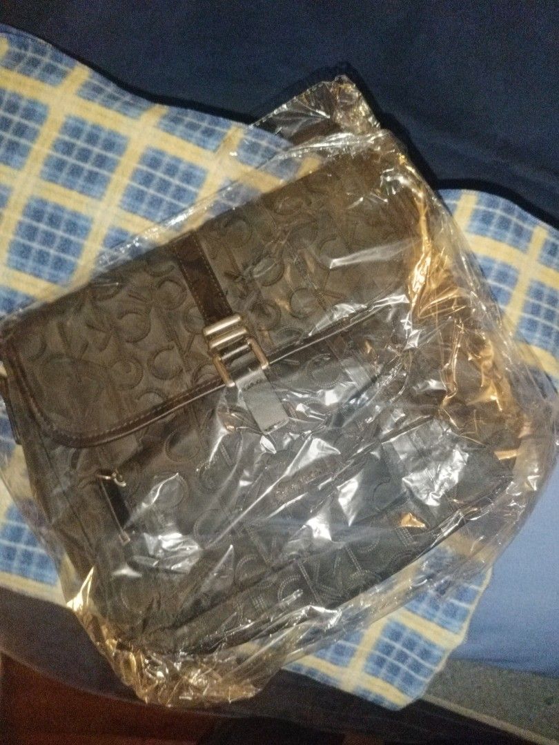 Calvin Klein Monogram Black Messenger Bag (Category: Sling Bags) located in Baguio. Submitted by valenzuela.jc (Listing ID 1465698402, Image 1). Description: Sourced from Canada - Brand: Calvin Klein - Style: Black messenger bag with iconic monogram print - Exterior: Front flap closure with metal buckle, zippered front pocket, and adjustable strap - Interior: Multiple compartments lined with matching monogram fabric - Material: Durable nylon / sy