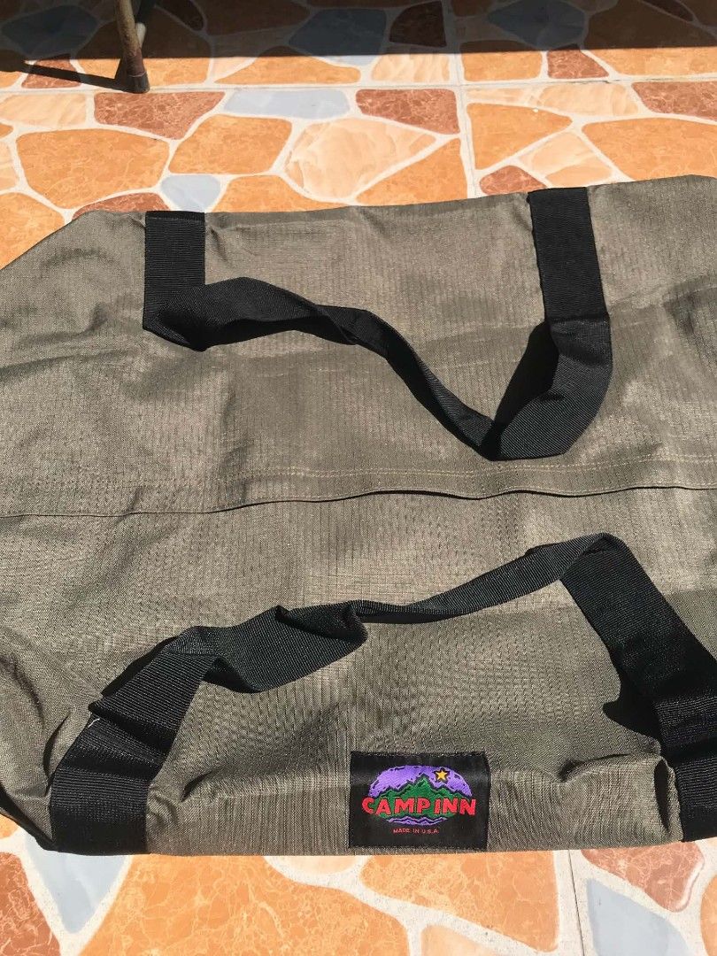 Camp Inn Olive Green Duffle Bag (Category: Sling Bags) located in Quezon City. Submitted by davidmelvin28 (Listing ID 1465590672, Image 2). Description: - Authentic Camp Inn duffle bag, proudly Made in U.S.A. - Color: Classic Olive Green with contrasting black hardware - Material: Heavy-duty textured fabric built for rugged use - Straps: Sturdy black nylon carry straps wrapped securely around the body - Features: Reinforced side attachment loops 