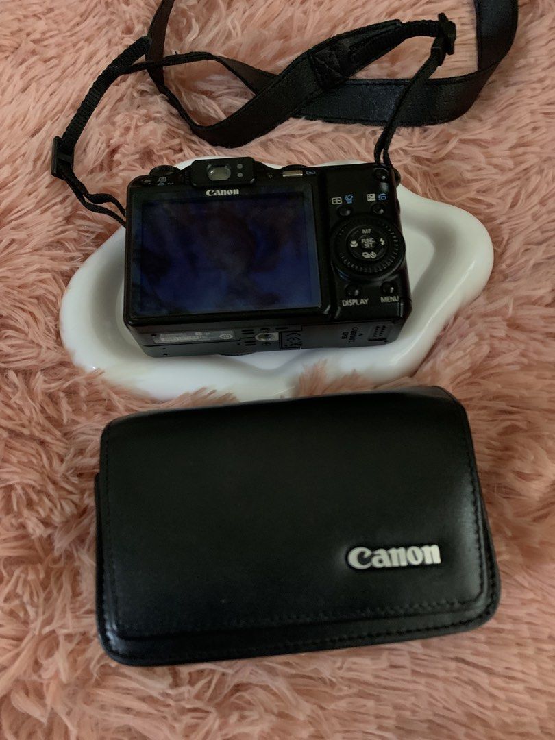 Canon PowerShot G9 Digital Camera with Case (Category: Cameras) located in Manila. Submitted by harrysuey (Listing ID 1465730977, Image 2). Description: No issue - Model: Canon PowerShot G9 digital camera (Black) - Included: Matching black Canon leather protective case and adjustable neck strap - Features: Optical zoom lens and rear LCD screen - Condition: Powers on and ready for shooting - Style: Compact vintage digital setup.