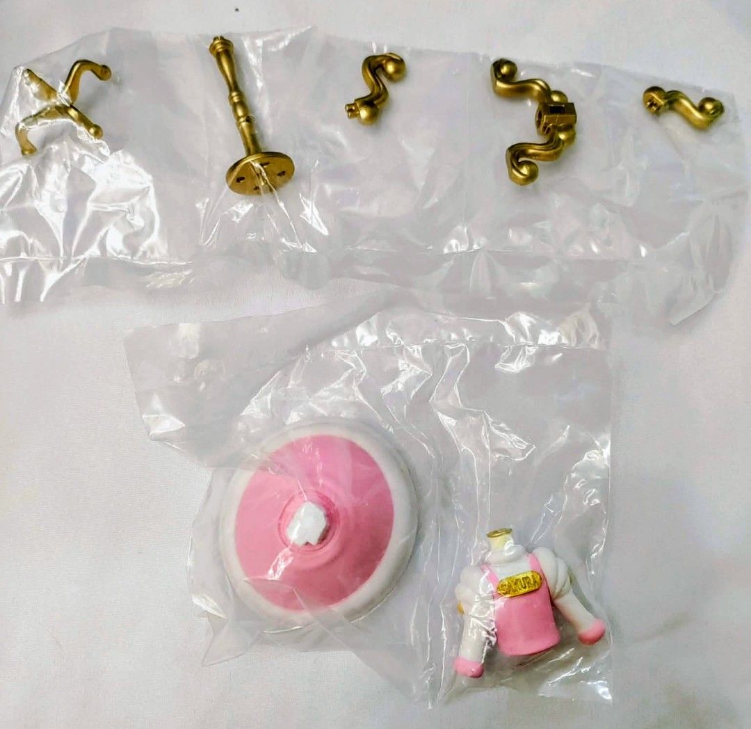 Cardcaptor Sakura gown with stand (Category: Figurines & Statues) located in Caloocan City. Submitted by jark_moonshop (Listing ID 1465714380, Image 1). Description: - Authentic Cardcaptor Sakura figure accessories - Includes pink circular base stand, torso piece with Sakura nameplate, and gold-colored decorative parts - Condition: Brand new, still sealed in original plastic packaging - Ideal for completing an incomplete figure or for custom DIY 
