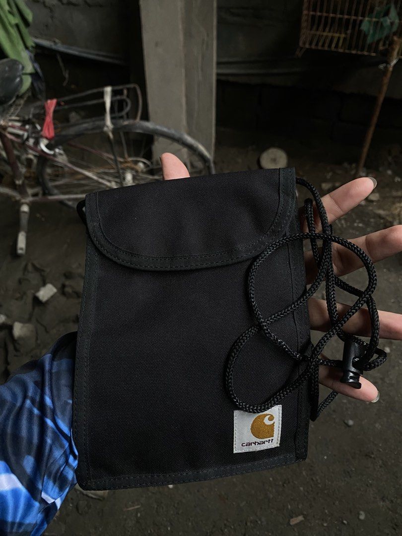 Carhartt WIP Collins Neck Pouch Black (Category: Belt bags, Clutches and Pouches) located in San Fernando. Submitted by thrifteezy6 (Listing ID 1465659871, Image 3). Description: - Brand: Carhartt WIP (Collins Neck Pouch) - Color: Classic Black - Size: One Size Fits All - Features: Handy front zip pocket, clear ID window, and main compartment with secure flap closure - Details: Adjustable black cord lanyard with toggle - Material: Durable, high-q