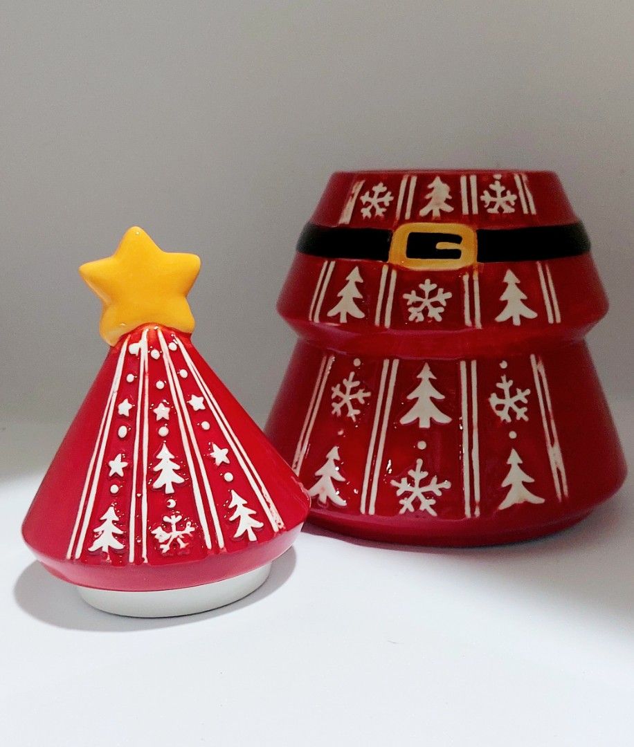 Ceramic Santa Christmas Tree Cookie Jar with Lid (Category: Everything Else Others) located in Cainta. Submitted by veronica2277 (Listing ID 1465621447, Image 2). Description: - Festive red ceramic Christmas tree cookie jar - Decorated with a Santa belt, white trees, and snowflakes - Yellow star acts as a convenient lid handle - Removable lid for easy refilling with cookies or candy - Great holiday decor for your kitchen counter or dining table b