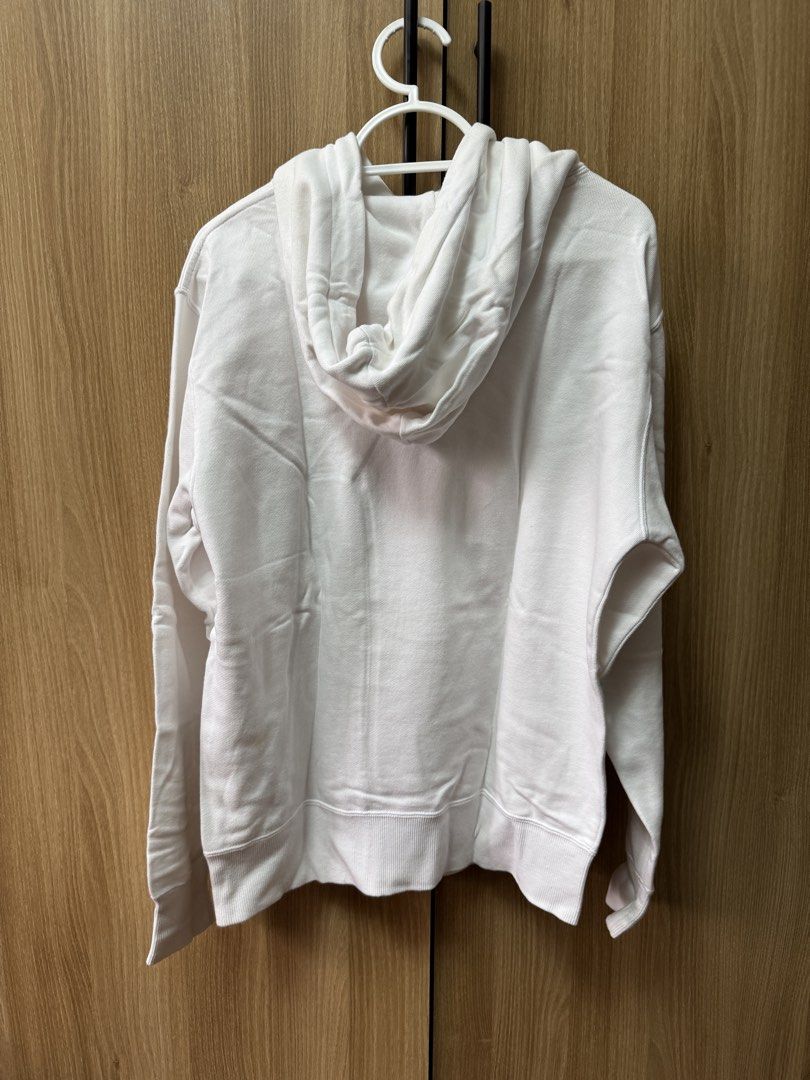 Champion White Hoodie Medium Script Logo (Category: Hoodies) located in Manila. Submitted by prinsloo_ (Listing ID 1465650043, Image 3). Description: - Brand: Champion - Color: White with big script logo across the chest - Size: Medium. Shoulder ~45cm, length ~58.5cm, sleeves ~57.5cm - Material: Comfortable, warm fleece - Features: Front kangaroo pocket, adjustable drawstring hood - Style: Classic casual streetwear - Condition: there are stains d