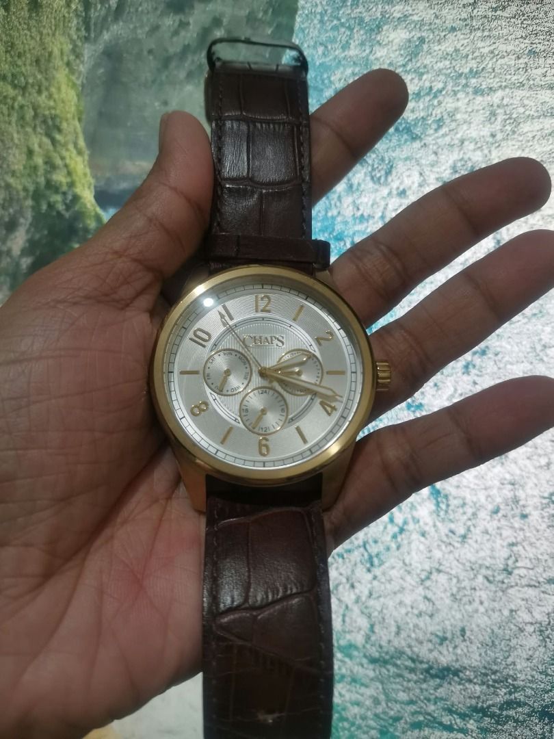 Chaps CHP5050 Gold Tone Watch (Category: Women's Watches) located in Manila. Submitted by mahanaim.67c328 (Listing ID 1465745256, Image 3). Description: - Brand: Authentic Chaps Analog Watch (Model CHP5050) - Dial: Textured silver with classic Arabic numerals and 3 sub-dials (day, date, 24-hour display) - Case: Elegant gold-tone with all stainless-steel back - Strap: Dark brown faux-Croco leather with gold buckle closure - Water Resistance: Up to