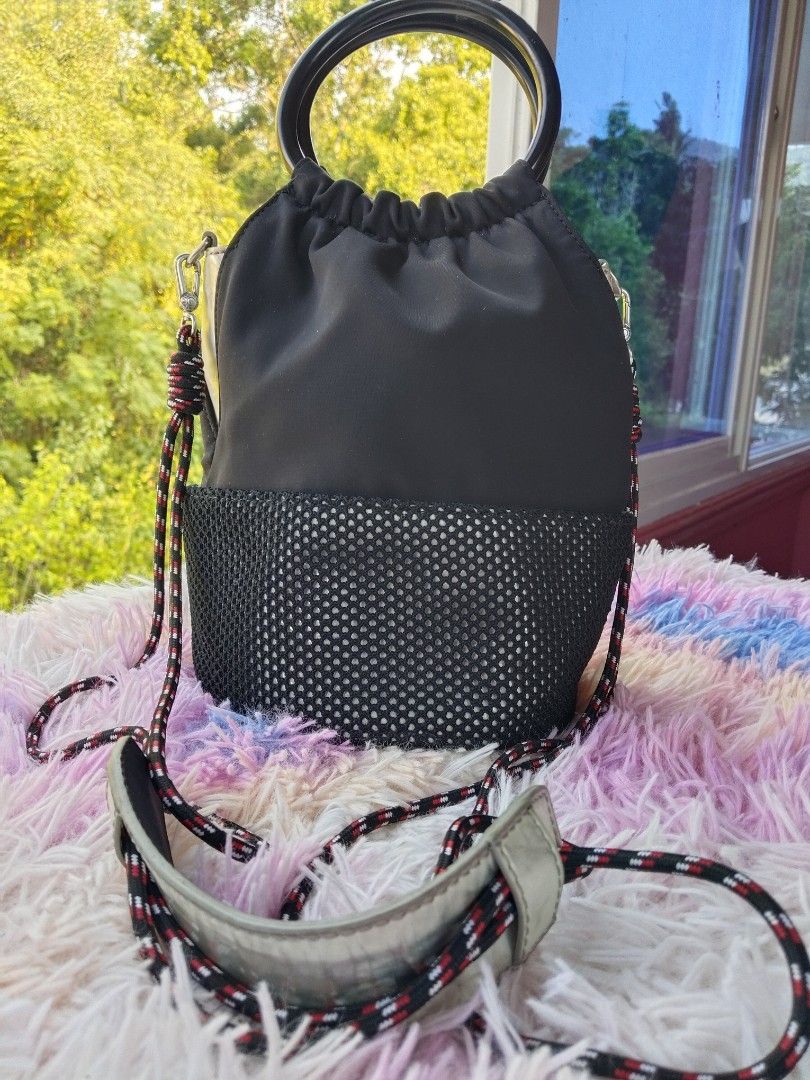 Charles & Keith Black Bucket Bag with Ring Handle (Category: Shoulder Bags) located in Siquijor. Submitted by thesummit26 (Listing ID 1465722968, Image 2). Description: The entire bottom base has severe, heavy peeling and cracking. It is hidden from view when you are wearing it. The silver metallic faux leather panels on the sides and the shoulder pad are showing noticeable flaking. .