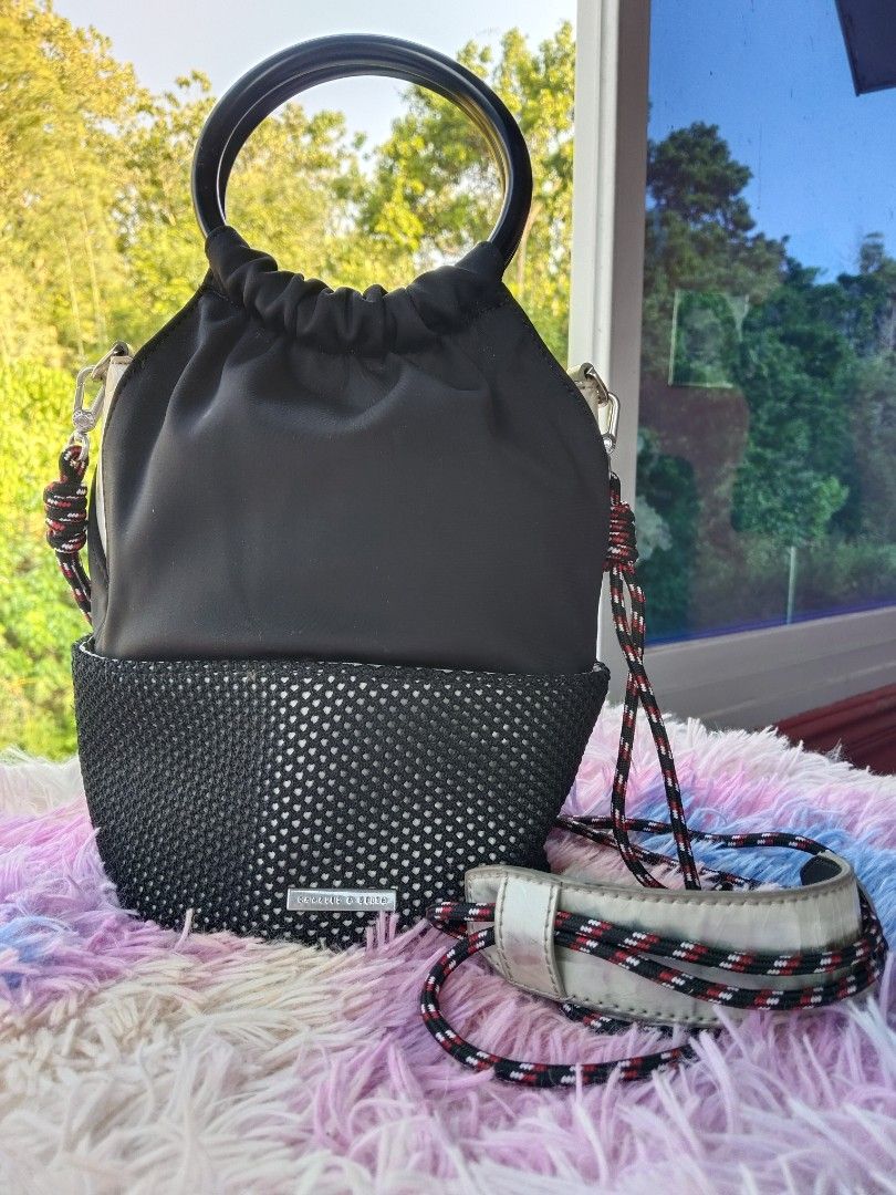 Charles & Keith Black Bucket Bag with Ring Handle (Category: Shoulder Bags) located in Siquijor. Submitted by thesummit26 (Listing ID 1465722968, Image 1). Description: The entire bottom base has severe, heavy peeling and cracking. It is hidden from view when you are wearing it. The silver metallic faux leather panels on the sides and the shoulder pad are showing noticeable flaking. .