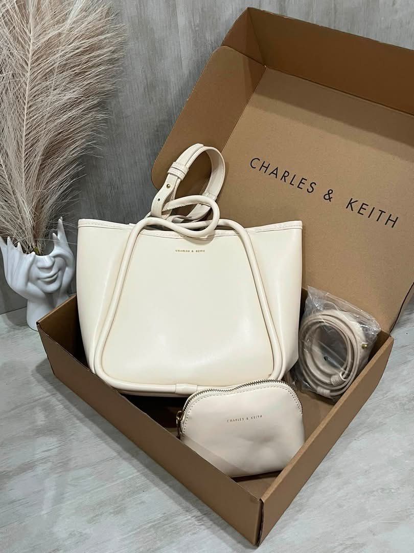 Charles & Keith lyla Tote Bag With pouch - Small (Category: Tote Bags) located in Pasig City. Submitted by bagsnmore4 (Listing ID 1465580984, Image 2). Description: - Brand: Charles & Keith - Color: Taupe - Cream versatile that matches any daily outfit - Inclusions: Main tote bag, matching pouch, and extra strap - Condition: Brand new .