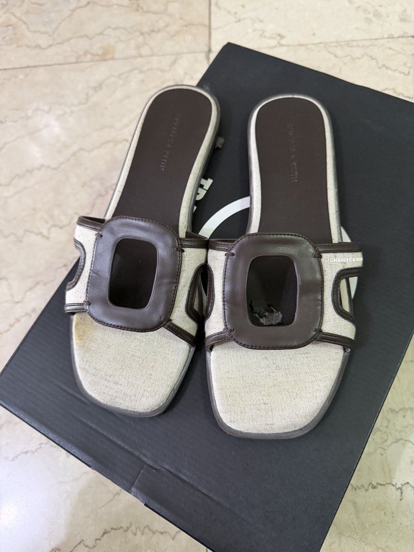 Charles & Keith Sandals size 39 (with flaws) (Category: Flats & Sandals) located in San Juan City. Submitted by smjose (Listing ID 1465641731, Image 2). Description: - Brand: Charles & Keith. Original - Size: 39 - Color: Brown and Cream - Style: Chic flat slip-on sandals with cut-out design - Condition: Pre-loved, still functional and usable, but has noticeable inner leather flaking No more box .