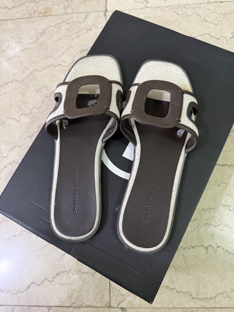 Charles & Keith Sandals size 39 (with flaws) (Category: Flats & Sandals) located in San Juan City. Submitted by smjose (Listing ID 1465641731, Image 1). Description: - Brand: Charles & Keith. Original - Size: 39 - Color: Brown and Cream - Style: Chic flat slip-on sandals with cut-out design - Condition: Pre-loved, still functional and usable, but has noticeable inner leather flaking No more box .