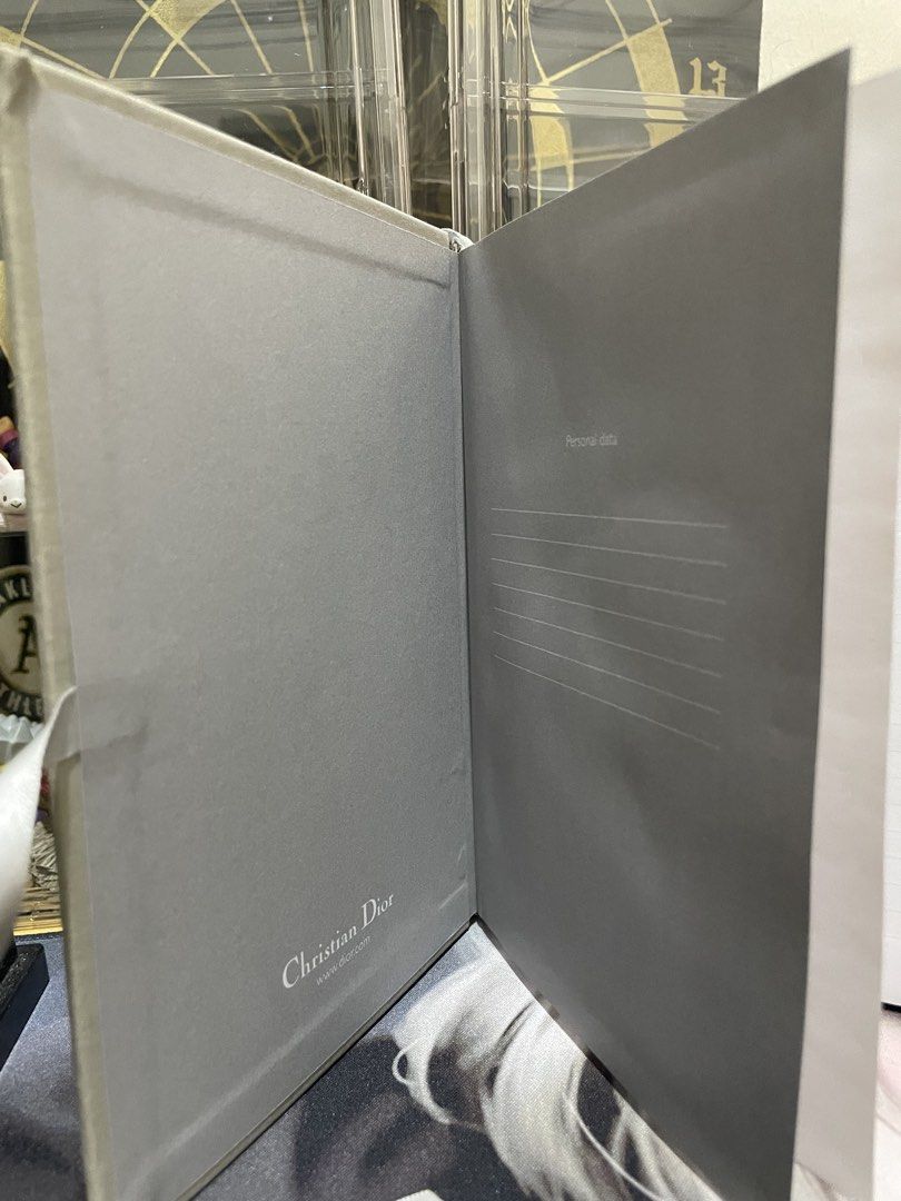 Christian Dior Exclusive Platinum Notebook Diary Journal (Category: Stationery & School Supplies) located in Agdangan. Submitted by kuradekawaii_06 (Listing ID 1465750382, Image 3). Description: CHECK PICTURES - Elegant cloth-bound grey cover with Dior Exclusive Platinum text on the front and Christian Dior on the back - Convenient built-in ribbon bookmark - Clean lined pages inside with a dedicated rose photo insert section - Includes a personal