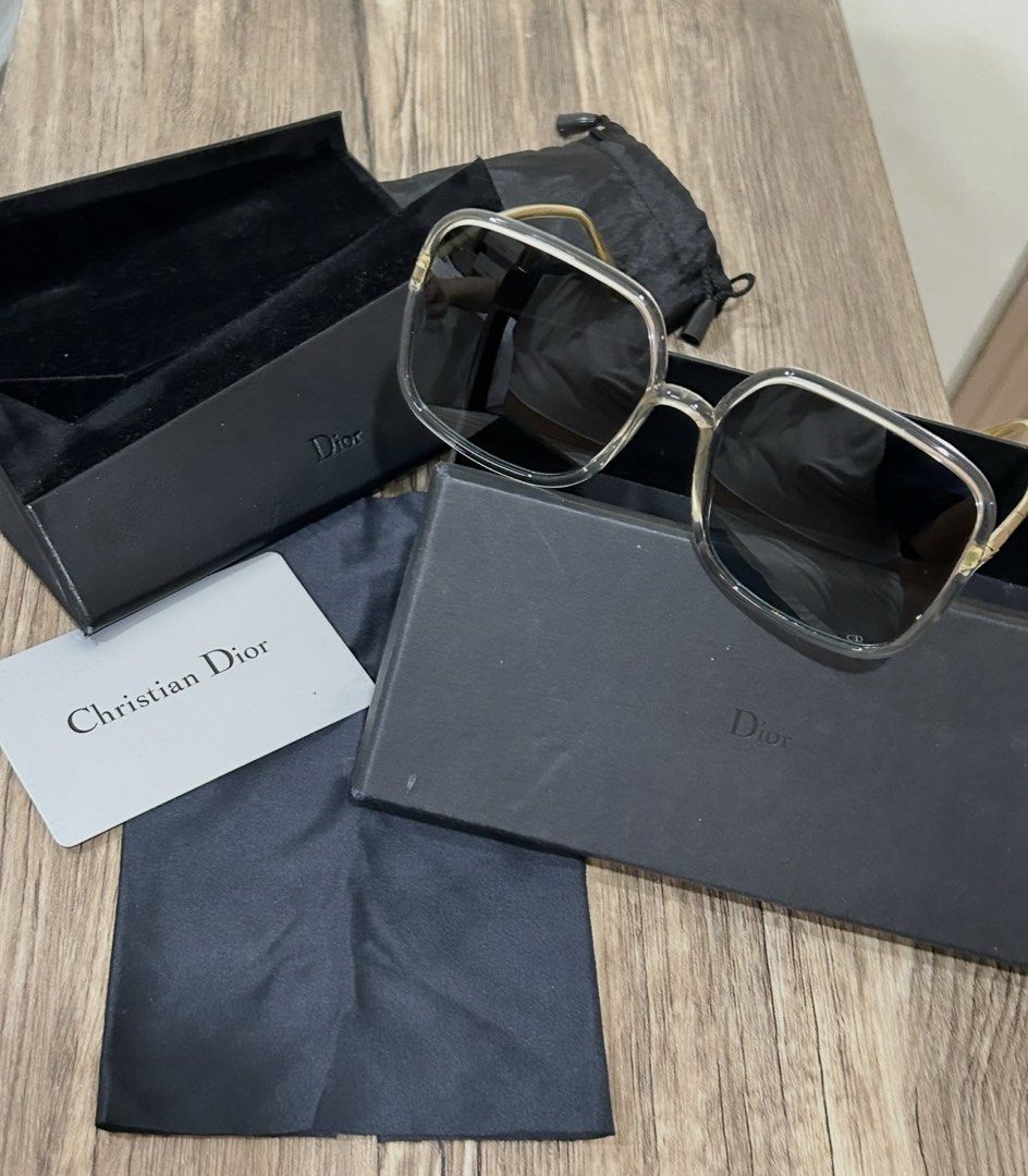 Christian Dior Square Sunglasses with Case (Category: Sunglasses & Eyewear) located in Manila. Submitted by eeerk (Listing ID 1465673472, Image 3). Description: - Brand: Christian Dior - Style: Oversized square sunglasses - Frame: Clear translucent with gold-tone temples and subtle CD logo - Lenses: Dark gradient - Inclusions: Branded hard case, black pouch, and information card - Condition: Great statement accessory for sunny days.