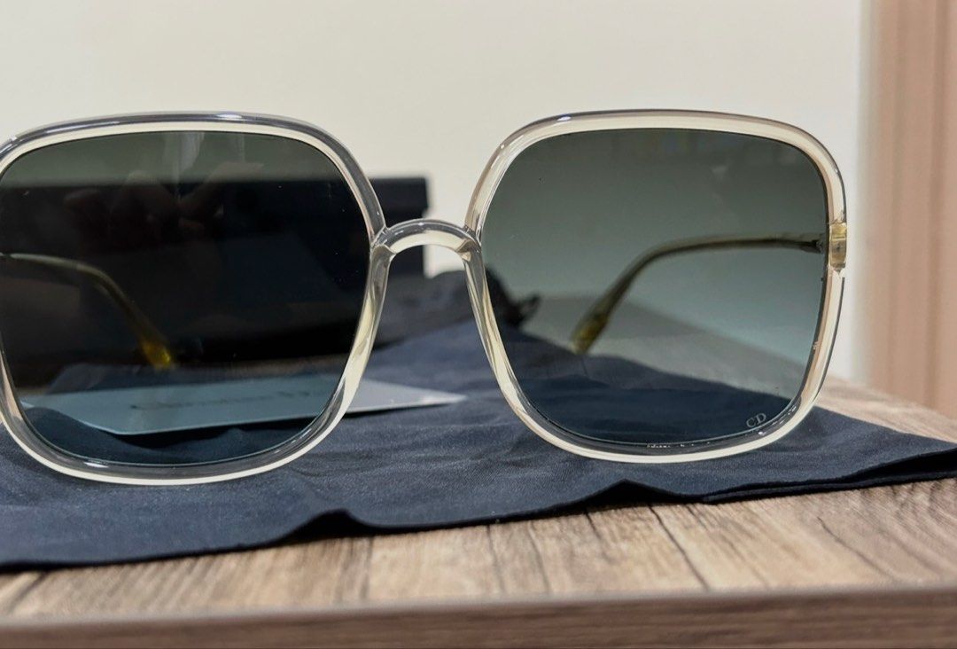 Christian Dior Square Sunglasses with Case (Category: Sunglasses & Eyewear) located in Manila. Submitted by eeerk (Listing ID 1465673472, Image 2). Description: - Brand: Christian Dior - Style: Oversized square sunglasses - Frame: Clear translucent with gold-tone temples and subtle CD logo - Lenses: Dark gradient - Inclusions: Branded hard case, black pouch, and information card - Condition: Great statement accessory for sunny days.