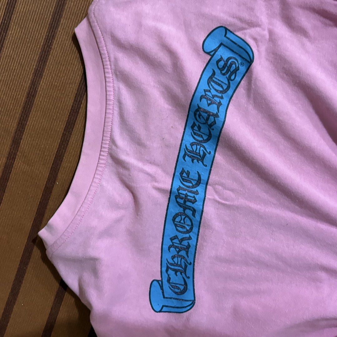 Chrome Hearts Pink Scroll Pocket T-Shirt (Category: Tshirts & Polo Shirts ) located in Manila. Submitted by carlmachu (Listing ID 1465704097, Image 3). Description: - Brand: Chrome Hearts - Color: Bright pink - Design: Blue scroll logo print on chest pocket and sleeve - Fit: Classic crew neck, short sleeve - Origin: Made in USA - Condition: Clean fabric overall with original collar branding.