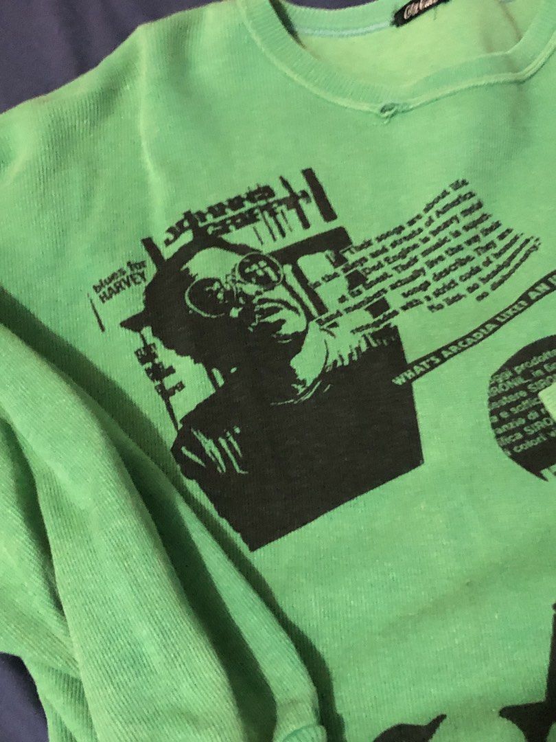 City Call Green Graphic Sweatshirt (Category: Coats, Jackets and Outerwear) located in Canaman. Submitted by stu333 (Listing ID 1465695577, Image 3). Description: - Brand: City Call - Color: Bright green - Design: Large black graphic print with portrait and text on the front - Details: Crew neckline with subtle distressing at the collar, long sleeves, ribbed cuffs and hem - Fit: Relaxed, casual street style.