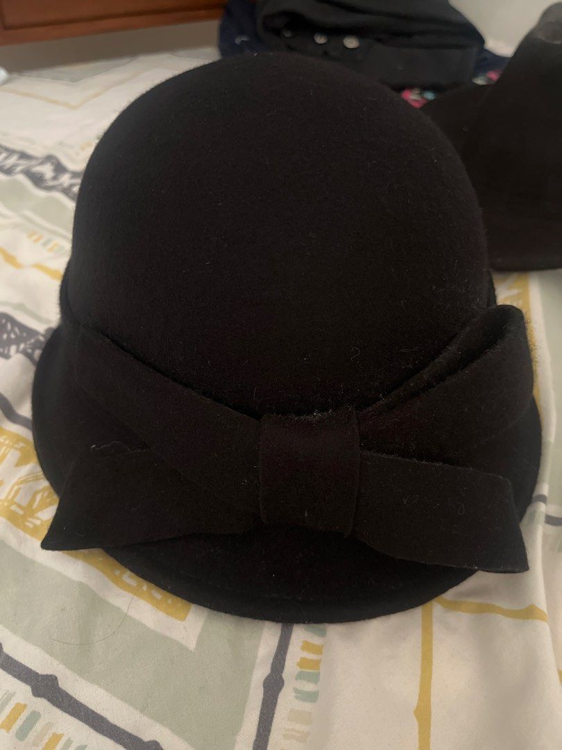 Classic Black Cloche Hat with Bow (Category: Hats & Beanies) located in Pasig City. Submitted by jnzmrq1003 (Listing ID 1465600671, Image 3). Description: - Color: Black - Material: Soft wool texture - Design: Rounded crown with a big side bow for a vintage vibe - Season: Ideal for autumn and winter - Fit: Standard fit that covers the head nicely.