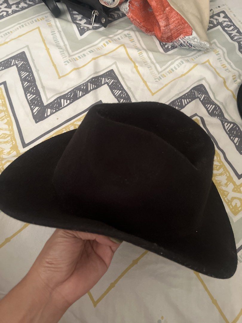 Classic Black Fedora Hat Cowboy Style (Category: Caps & Hats) located in Pasig City. Submitted by jnzmrq1003 (Listing ID 1465602027, Image 1). Description: - Color: Solid black - Design: Wide brim and pinched crown shape - Material: Sturdy, structured fabric that holds its shape well - Versatility: Simple and stylish, ideal for daily wear or outdoor events - Condition: Brand new and ready to ship!.