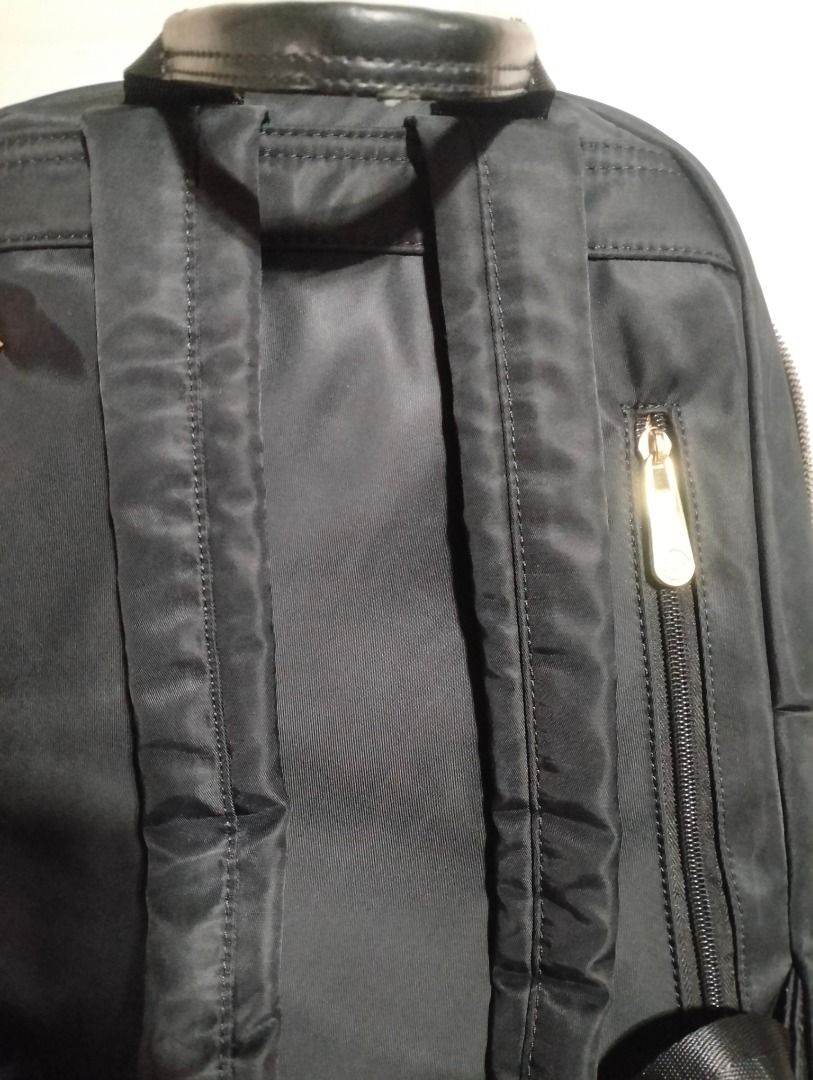 CLN Black Backpack (Category: Backpacks) located in Cavite. Submitted by brightfire.b90615 (Listing ID 1465665302, Image 3). Description: - Main compartment with sturdy zippers, front zipped pocket, and drawstring detail with knots - Adjustable shoulder straps and top carry handle - Condition: Fully functional with normal signs of handling; notable wear and scuffing on the top leather handle, and slight fraying along the zipper fabric tracks.