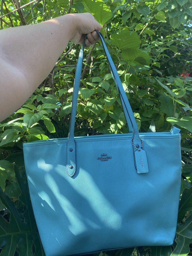 Coach Blue Leather Tote Bag (Category: Tote Bags) located in Manila. Submitted by cdb_22 (Listing ID 1465597230, Image 1). Description: - Authentic bright blue Coach tote in luxurious pebbled leather - Spacious interior with plenty of room for daily essentials - Comfortable twin shoulder straps with sleek silver-toned hardware - Includes the iconic original Coach hangtag - Features a clean structure and a subtle silver Coach logo stamp on the fro