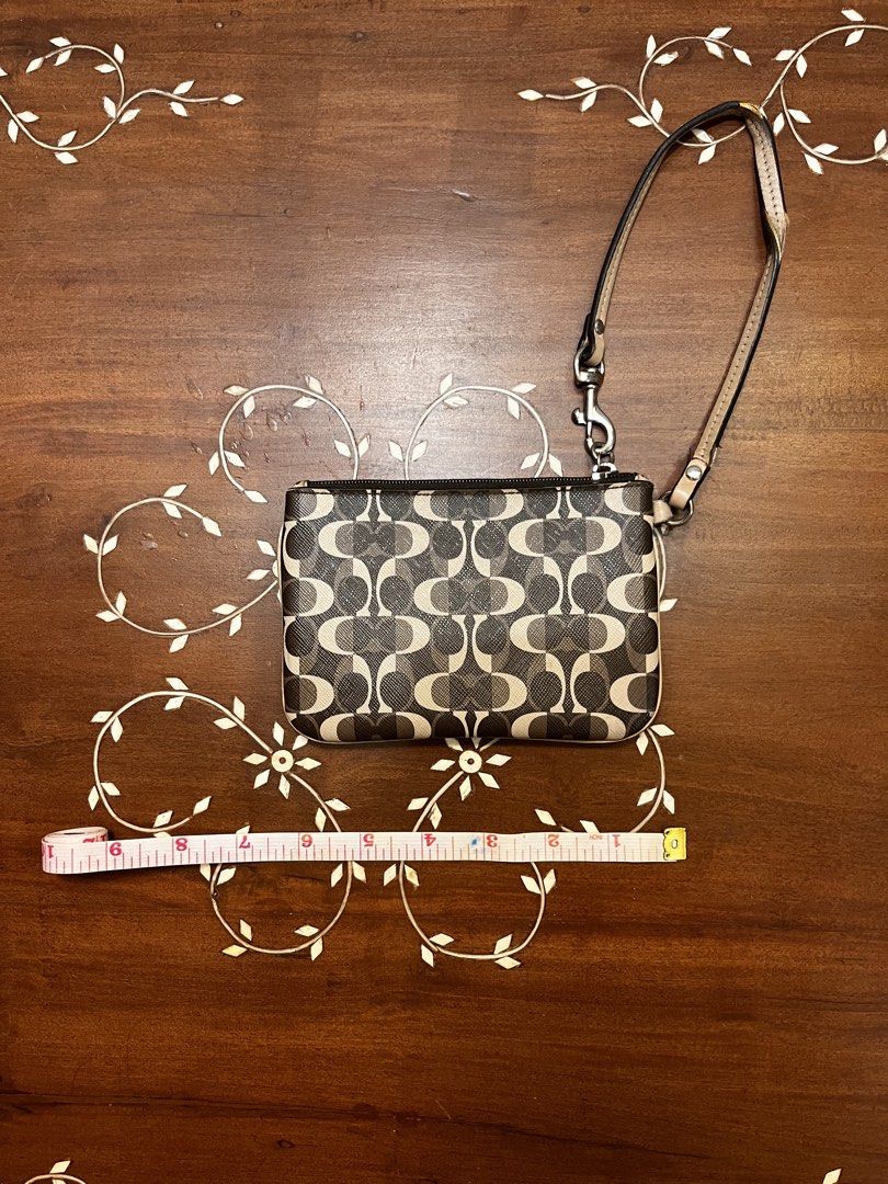 Coach Brown Coated Canvas Wristlet (Category: Luxury Bags & Wallets) located in Manila. Submitted by lalalens._ (Listing ID 1465674483, Image 2). Description: vintage coach monogram printed leather wristlet good leather body condition, handle has tears (see pics for condition). fixed price + SF !.