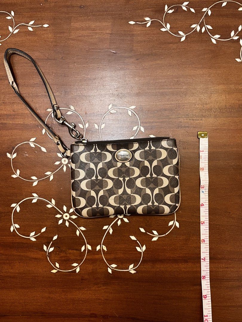 Coach Brown Coated Canvas Wristlet (Category: Luxury Bags & Wallets) located in Manila. Submitted by lalalens._ (Listing ID 1465674483, Image 1). Description: vintage coach monogram printed leather wristlet good leather body condition, handle has tears (see pics for condition). fixed price + SF !.