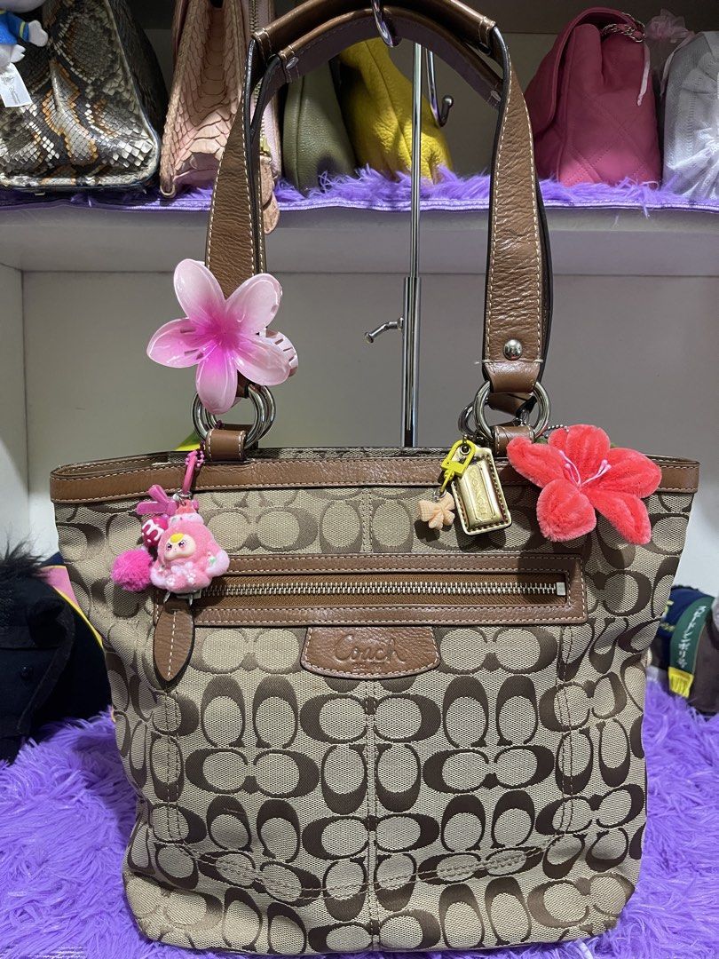 Coach Penelope shopper tote bag (Category: Luxury Bags & Wallets) located in Manila. Submitted by just_loved (Listing ID 1465745340, Image 1). Description: - Authentic Coach signature C canvas body in beige and brown - Premium brown leather trim, dual straps, and gold hardware - Front exterior zip pocket with Coach leather patch and iconic hangtag - Pre-accessorized with cute charms and hair clips attached to rings and zipper - Spacious everyday 