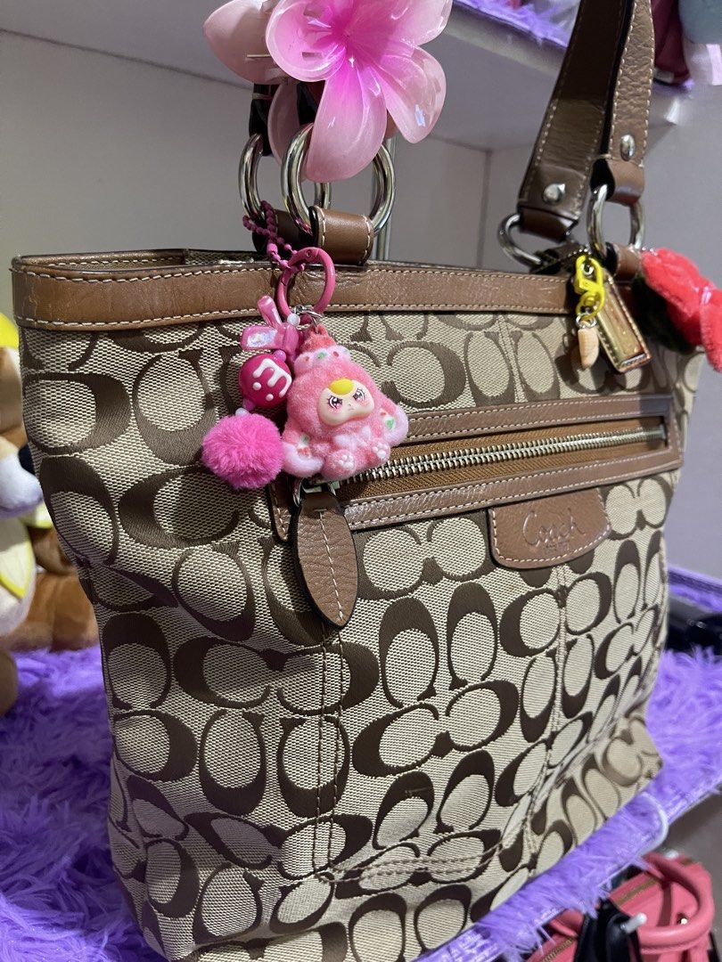 Coach Penelope shopper tote bag (Category: Luxury Bags & Wallets) located in Manila. Submitted by just_loved (Listing ID 1465745340, Image 2). Description: - Authentic Coach signature C canvas body in beige and brown - Premium brown leather trim, dual straps, and gold hardware - Front exterior zip pocket with Coach leather patch and iconic hangtag - Pre-accessorized with cute charms and hair clips attached to rings and zipper - Spacious everyday 