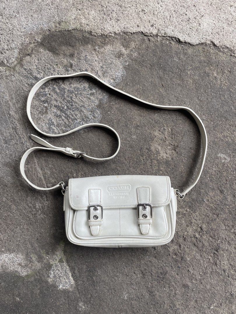 Coach Leatherware Est. 1941 White Crossbody Bag (Category: Cross-body Bags) located in Polomolok. Submitted by madagascarts (Listing ID 1465608307, Image 1). Description: - Authentic Coach crossbody bag in classic off-white leather - Features a stylish front flap with dual buckle closures and an adjustable shoulder strap - Interior lined with fabric, featuring a secure zip pocket with reliable YKK hardware - Includes official creed patch (No. K30
