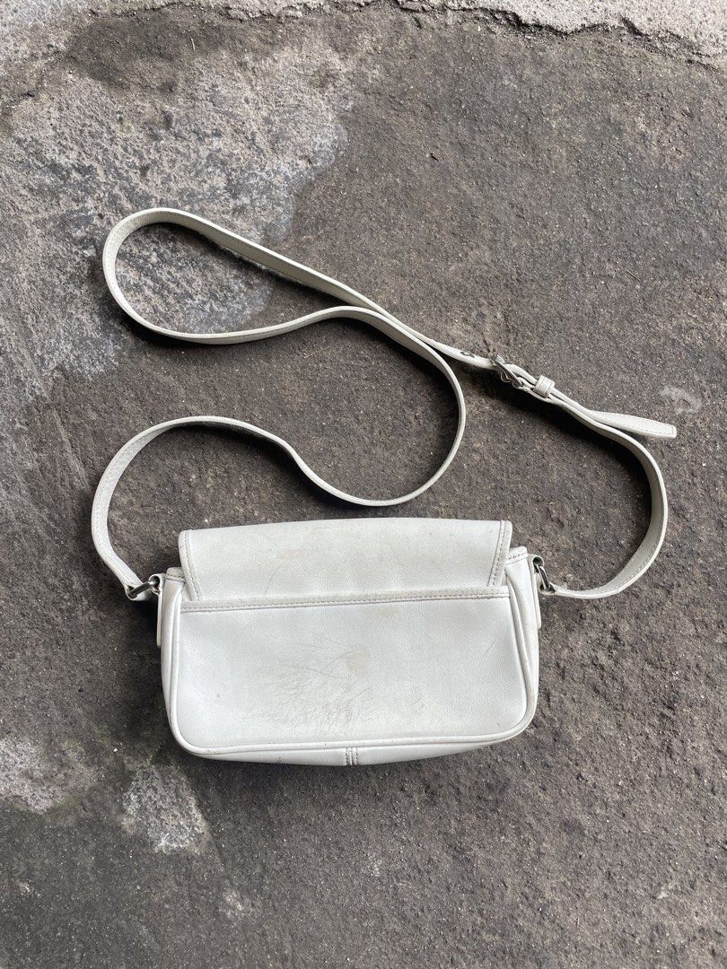 Coach Leatherware Est. 1941 White Crossbody Bag (Category: Cross-body Bags) located in Polomolok. Submitted by madagascarts (Listing ID 1465608307, Image 2). Description: - Authentic Coach crossbody bag in classic off-white leather - Features a stylish front flap with dual buckle closures and an adjustable shoulder strap - Interior lined with fabric, featuring a secure zip pocket with reliable YKK hardware - Includes official creed patch (No. K30