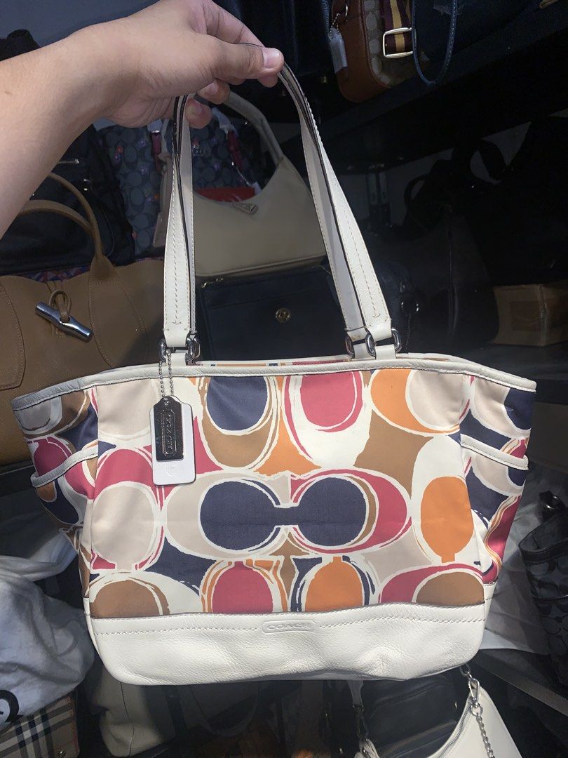 Coach Multi-Color Signature Tote Bag (Category: Luxury Bags & Wallets) located in Mataasnakahoy. Submitted by grailsph.81630 (Listing ID 1465747123, Image 1). Description: - Authentic Coach tote bag with a fun signature poppy graffiti colorful print - Stylish white leather trim at the bottom and dual comfortable shoulder straps - Convenient side slip pockets for easy access to essentials - Secure top zipper closure to keep your items safe - Clean
