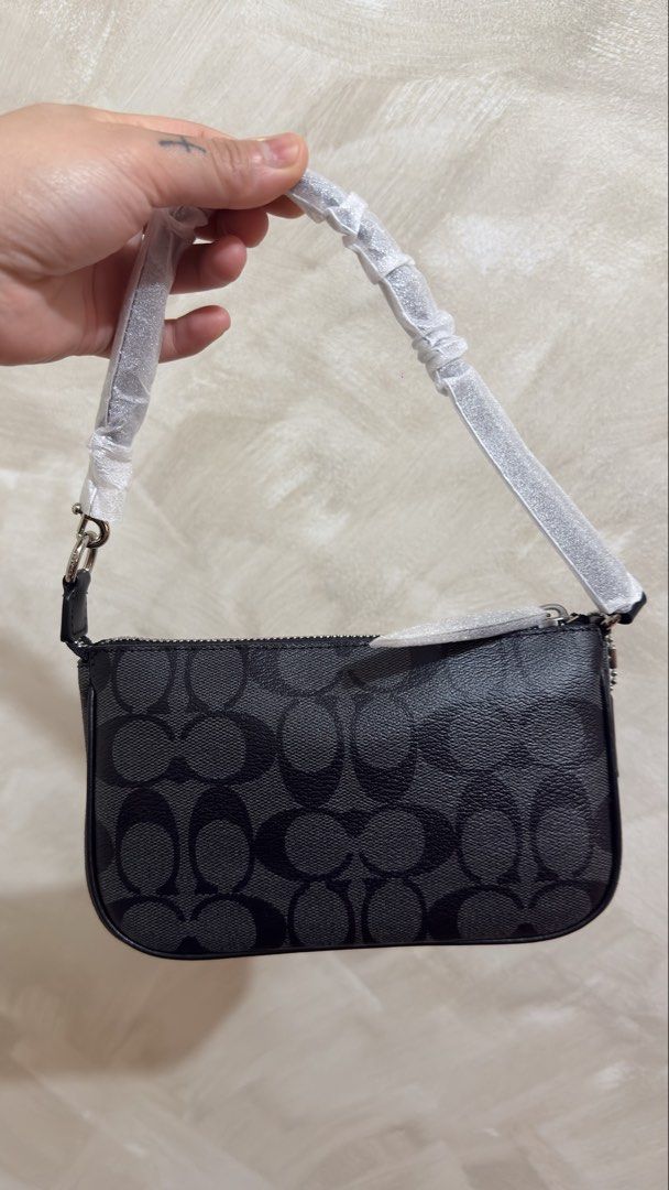 Coach Nolita 19 (Category: Shoulder Bags) located in Las Pinas. Submitted by mharjrahm (Listing ID 1465593849, Image 2). Description: - Brand: Coach - Style: Mini shoulder bag - Material: Black signature coated canvas - Hardware: Silver - Closure: Zip-top - Condition: Brand new with protective wrapping on strap and zipper pull - Features: Structured shape, compact size, versatile everyday design coach nolita 19 onhand pinas brandnew original 4900