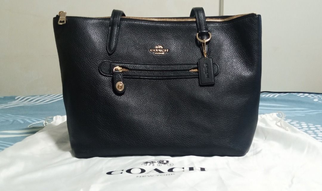 Coach Pebble tote bag (Category: Luxury Bags & Wallets) located in Caloocan City. Submitted by gelee35 (Listing ID 1465590009, Image 2). Description: · ‎Colour: Black/ Gold · ‎Shoulder/ Tote/ Document Bag · ‎Calf Leather · ‎Coach Metallic Lettering Logo · ‎Front Exterior Zip Pocket with Classic Turnlock Closure · ‎Double Leather Shoulder Straps · ‎Top Zip Closure · ‎Gold-Toned Hardware · ‎1 Interior Zip Pocket; 2 Interior Slip Pockets · ‎Coach Si