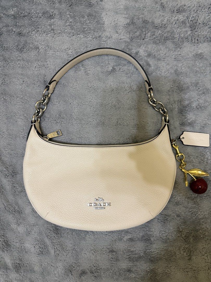 Coach Python Large Size (Category: Luxury Bags & Wallets) located in Bato. Submitted by babylaarni26255 (Listing ID 1465758651, Image 1). Description: - Authentic Coach shoulder bag in white pebbled leather - Silver-tone hardware and secure zipper closure - Stylish chain link accents on the strap - Includes a blank hangtag and adorable cherry bag charm with a gold stem and leaf - Compact and lightweight, ideal for daily essentials - Excellent, cl