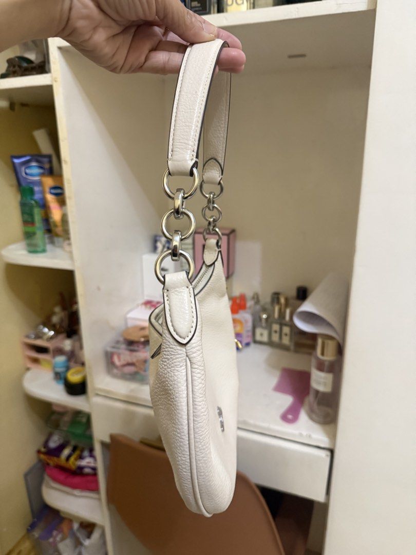 Coach Python Large Size (Category: Luxury Bags & Wallets) located in Bato. Submitted by babylaarni26255 (Listing ID 1465758651, Image 3). Description: - Authentic Coach shoulder bag in white pebbled leather - Silver-tone hardware and secure zipper closure - Stylish chain link accents on the strap - Includes a blank hangtag and adorable cherry bag charm with a gold stem and leaf - Compact and lightweight, ideal for daily essentials - Excellent, cl