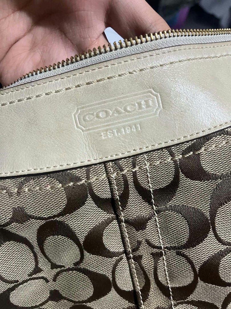 Coach Signature C Beige White Shoulder Bag (Category: Luxury Bags & Wallets) located in Quezon City. Submitted by darlenecamero_08 (Listing ID 1465625880, Image 3). Description: - Authentic Coach signature C jacquard fabric with white leather trim - Cream fabric interior lining with zipper top closure and creed patch (L0694-10402) - Noticeable wear and fraying at the bottom corner edge - Light marks on the white leather exterior panels - Affordab