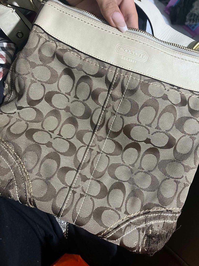 Coach Signature C Beige White Shoulder Bag (Category: Luxury Bags & Wallets) located in Quezon City. Submitted by darlenecamero_08 (Listing ID 1465625880, Image 1). Description: - Authentic Coach signature C jacquard fabric with white leather trim - Cream fabric interior lining with zipper top closure and creed patch (L0694-10402) - Noticeable wear and fraying at the bottom corner edge - Light marks on the white leather exterior panels - Affordab