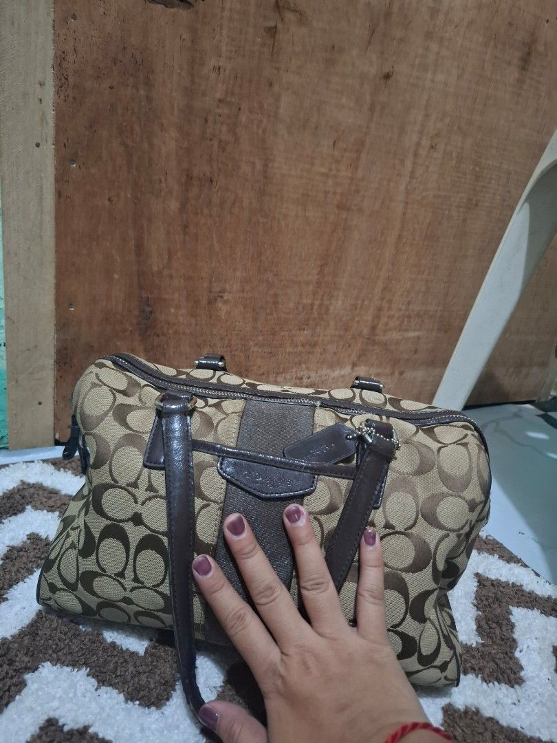 Coach Signature C Brown Canvas Shoulder Bag (Category: Luxury Bags & Wallets) located in Pasig City. Submitted by pingsrarefinds (Listing ID 1465720218, Image 3). Description: - Authentic Coach shoulder bag in classic brown signature C canvas - Dark brown leather handles, trim, and matching hangtag - Secure top zipper closure to keep your belongings safe - Roomy main compartment with great everyday utility - Solid hardware detailing throughout.