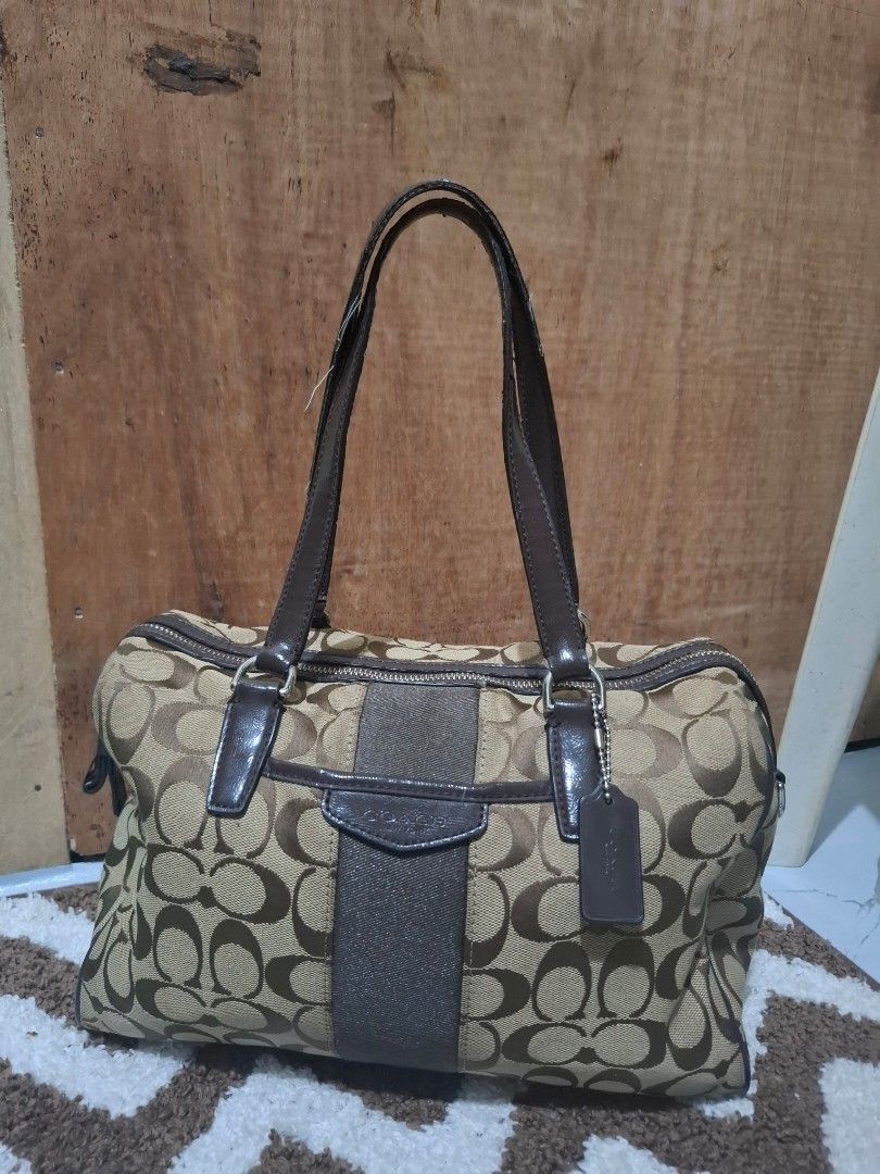 Coach Signature C Brown Canvas Shoulder Bag (Category: Luxury Bags & Wallets) located in Pasig City. Submitted by pingsrarefinds (Listing ID 1465720218, Image 1). Description: - Authentic Coach shoulder bag in classic brown signature C canvas - Dark brown leather handles, trim, and matching hangtag - Secure top zipper closure to keep your belongings safe - Roomy main compartment with great everyday utility - Solid hardware detailing throughout.