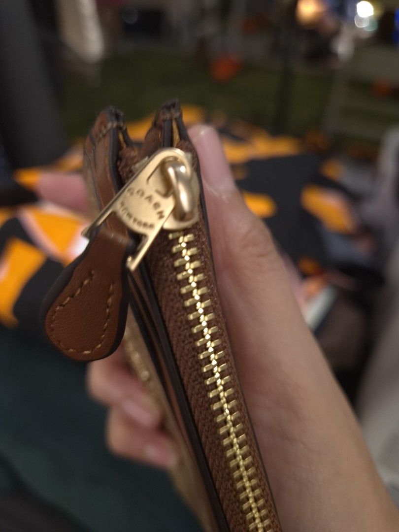 Coach Signature Canvas Mini Zip Case Brown (Category: Luxury Bags & Wallets) located in Paranaque City. Submitted by regf_01 (Listing ID 1465669719, Image 3). Description: - Authentic Coach Card Case - Color: Brown Signature Canvas with Tan Leather Trim - Hardware: Gold-tone - Closure: Zip-top with leather pull - Features: ID window on one side, multiple card slots on the other - Size: Compact, fits easily in pockets and small bags - Condition: L