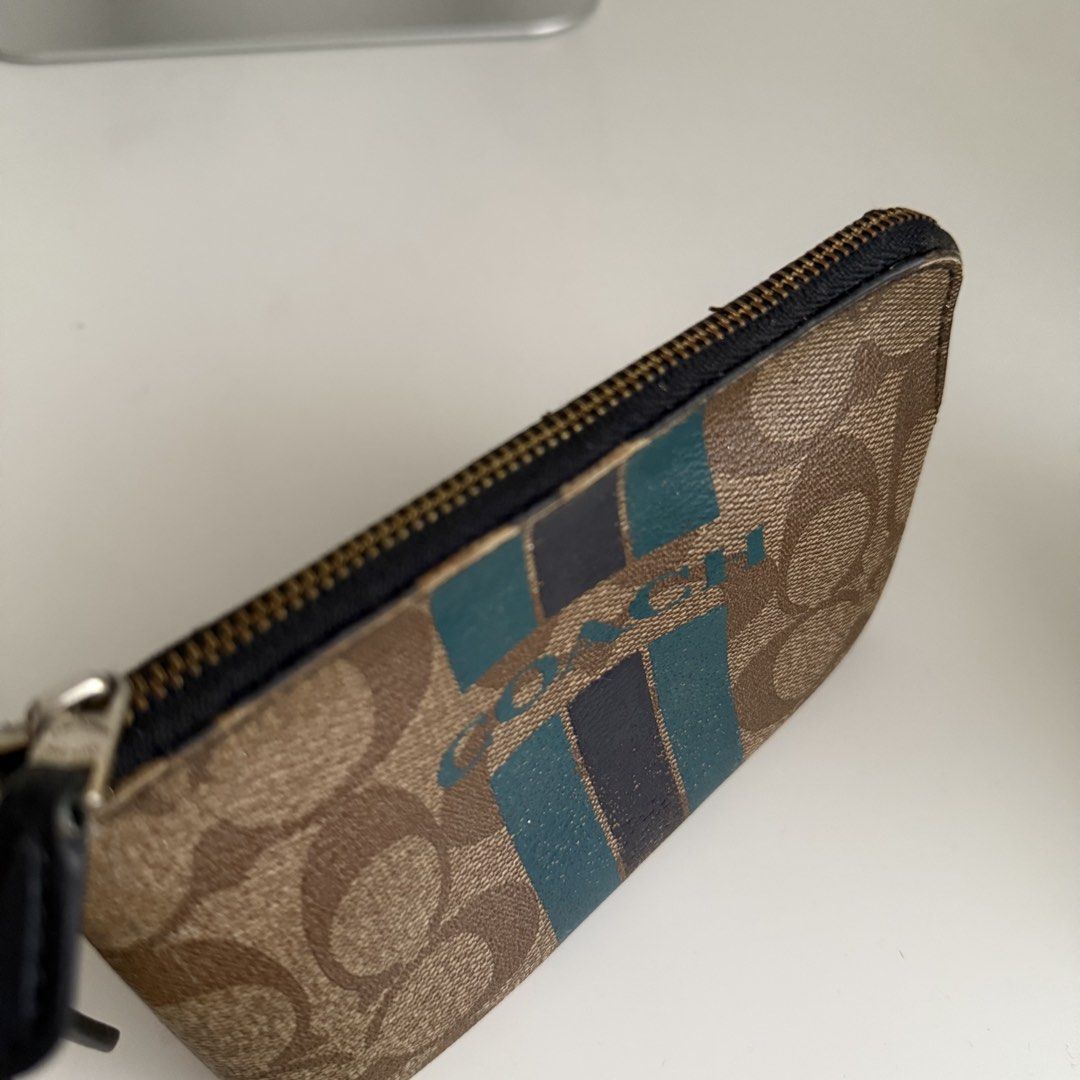 Coach Signature Wristlet (Category: Luxury Bags & Wallets) located in Quezon City. Submitted by 0ffTheRack (Listing ID 1465607799, Image 3). Description: - Authentic Coach signature canvas wristlet - Needs cleaning - Issue: rubber lining - Firm and last price.