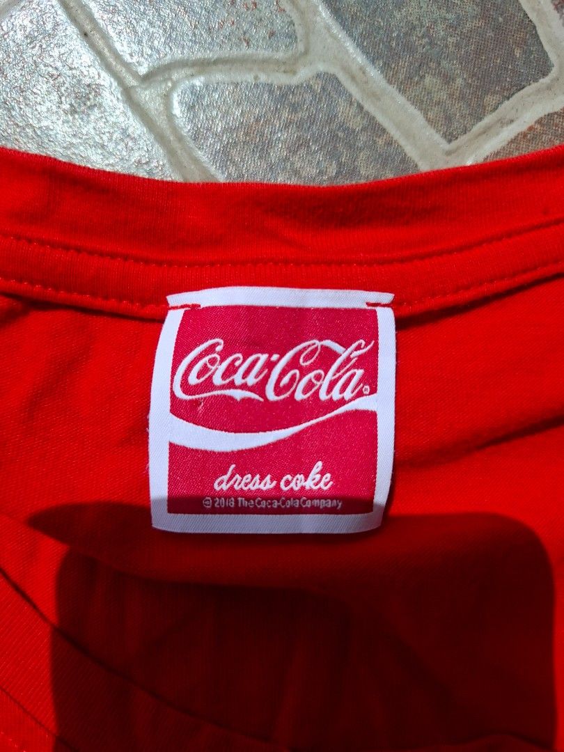 Coca-Cola Red Tank Top (Category: Sleeveless) located in Manila. Submitted by baguioseller (Listing ID 1465621046, Image 1). Description: - Color: Bright red with grey graphic and white chest logo - Authentic official Coca-Cola dress code merch - Material: Lightweight and breathable cotton - Fit: Relaxed fit for maximum comfort - Condition: Great casual piece, perfect for hot weather.
