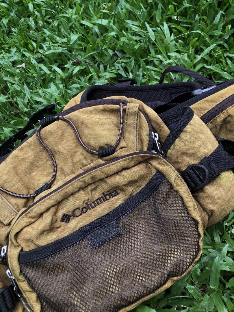 Columbia Brown Hiking Vest Backpack (Category: Backpacks) located in Kabasalan. Submitted by hamugaway (Listing ID 1465755068, Image 2). Description: - Brand: Columbia - Style: Outdoor backpack vest hybrid - Color: Brown - Size: Unisex (Tag shows O/S) - Design: Mesh front pocket, bungee cord detail, multiple compartments, and side utility pouches - Comfort: Adjustable straps with a padded back panel - Interior: Clean lining with Columbia branding