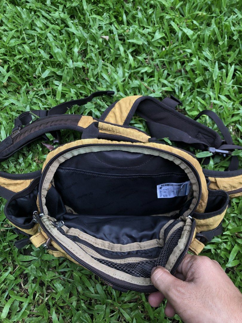 Columbia Brown Hiking Vest Backpack (Category: Backpacks) located in Kabasalan. Submitted by hamugaway (Listing ID 1465755068, Image 3). Description: - Brand: Columbia - Style: Outdoor backpack vest hybrid - Color: Brown - Size: Unisex (Tag shows O/S) - Design: Mesh front pocket, bungee cord detail, multiple compartments, and side utility pouches - Comfort: Adjustable straps with a padded back panel - Interior: Clean lining with Columbia branding