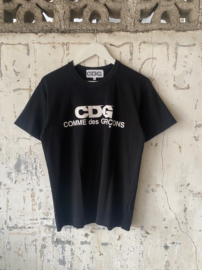 Comme des Garcons - White Logo Tee (Category: Tshirts & Polo Shirts ) located in Puerto Princesa. Submitted by something___. (Listing ID 1465670941, Image 2). Description: Comme des Garcons - White Logo Tee Tagged Size: Medium (Dimension) Length: 26 Width: 20.5 Condition: Excellent Color rate: 9.8 Flaws: None.