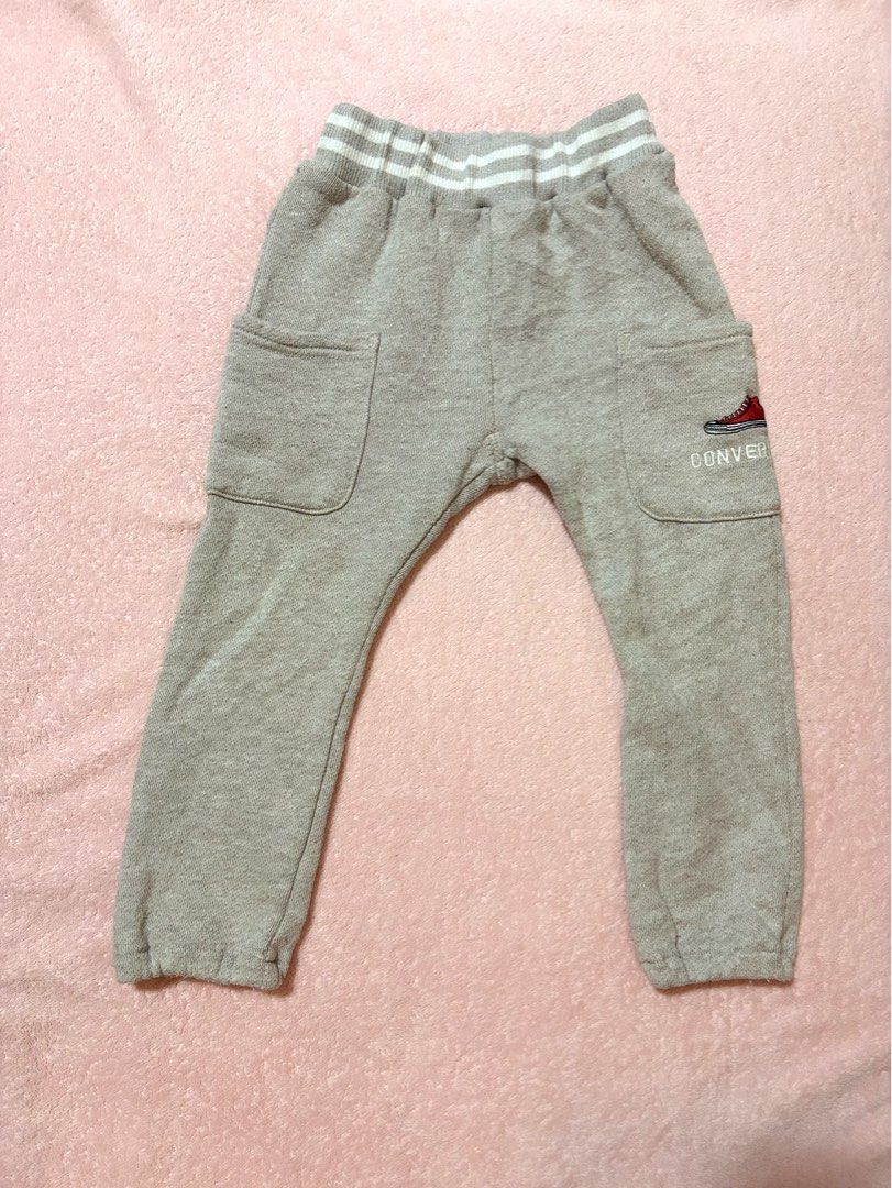 Converse heather grey fleece sweatpants (Category: Babies & Kids Fashion) located in Quezon City. Submitted by closettreasure123 (Listing ID 1465617368, Image 1). Description: 2-3yrs old featuring an elastic waistband with white athletic stripes, two large patch pockets on the front, and a signature red Chuck Taylor sneaker logo embroidered on the left pocket along with the “CONVERSE” text branding..