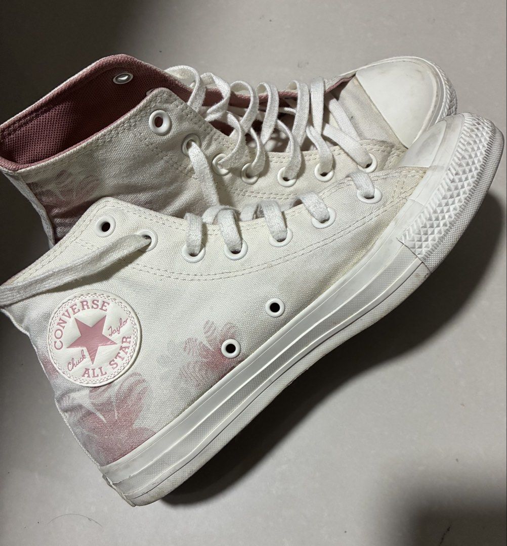 Converse Sakura Pink Chuck Taylor All Star (Category: Sneakers) located in Manila. Submitted by jhie24 (Listing ID 1465681708, Image 1). Description: - Brand: Converse Chuck Taylor High Top - Color/Pattern: Off-white canvas with pink floral graphic print - Interior: Soft pink lining for added comfort - Details: Classic white laces and durable rubber toe caps - Condition: Good, with minor scuffs on the toe rubber from normal wear.