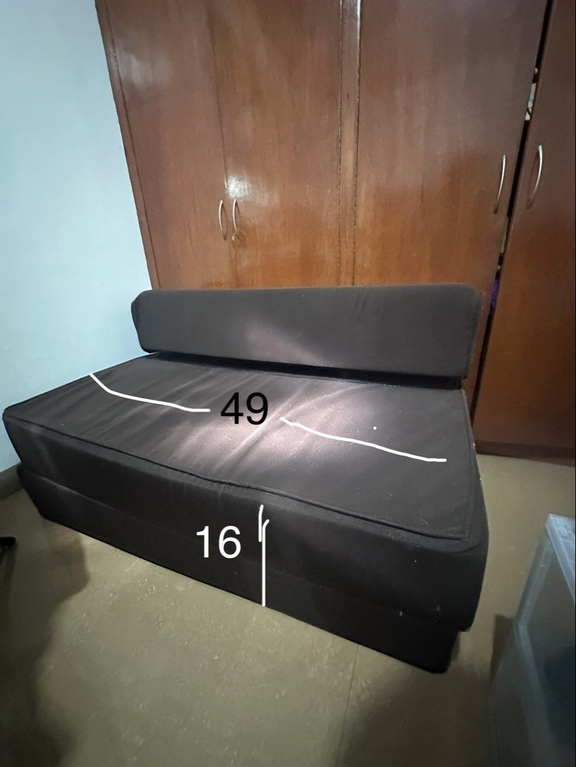 Convertible Sofa Bed Dark Brown Foldable Futon (Category: Sofas) located in Las Pinas. Submitted by treyyywayyy (Listing ID 1465652320, Image 1). Description: - Color: Dark brown solid fabric upholstery - Function: Easily converts from sofa to flat mattress with a cushioned folding backrest - Dimensions (flat): 76.5 inches long, 49 inches wide, 8 inches thick - Condition: Shows minor fuzz and lint accumulation on the surface - Best for: Living ro