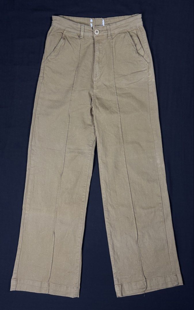 Cotton On Khaki Wide Leg Pants (Category: Jeans) located in Bacoor. Submitted by calvinmanzano13 (Listing ID 1465618522, Image 1). Description: - L = 40” | W = 27” - Style: Wide leg pants with relaxed fit and front crease detail - Closure: Front button with belt loops - Pockets: Two functional back pockets - Material: 90% cotton, 10% recycled cotton (eco-friendly) Notes: ☑️ Hand washed ☑️ Polished ☑️ Steam ironed.