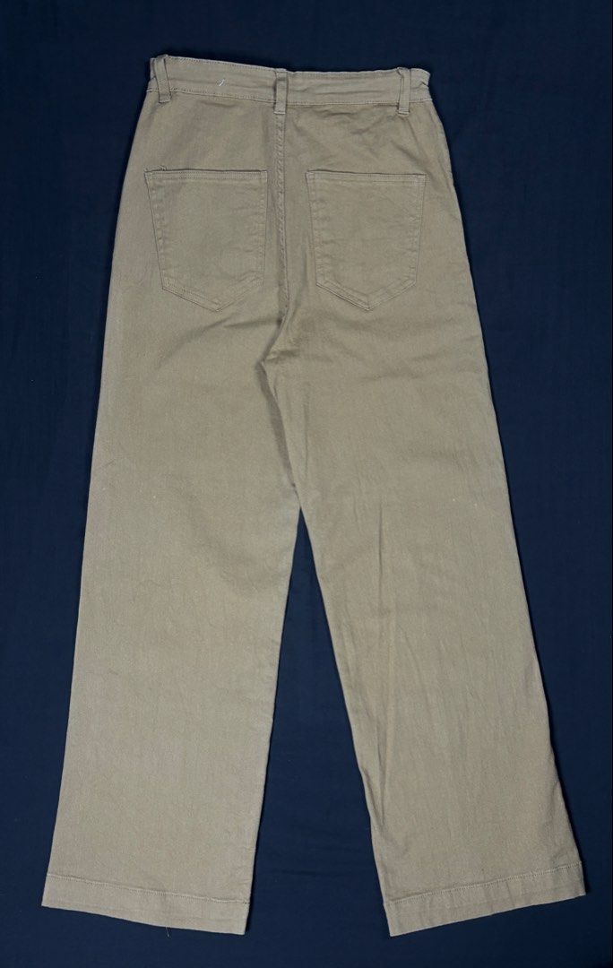 Cotton On Khaki Wide Leg Pants (Category: Jeans) located in Bacoor. Submitted by calvinmanzano13 (Listing ID 1465618522, Image 3). Description: - L = 40” | W = 27” - Style: Wide leg pants with relaxed fit and front crease detail - Closure: Front button with belt loops - Pockets: Two functional back pockets - Material: 90% cotton, 10% recycled cotton (eco-friendly) Notes: ☑️ Hand washed ☑️ Polished ☑️ Steam ironed.